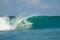 Surfer on perfect blue big tube wave, empty line up, perfect for surfing, clean water, Indian Ocean in Mentawai islands