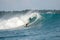 Surfer on perfect blue big tube wave, empty line up, perfect for surfing, clean water, Indian Ocean in Mentawai islands