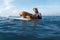 Surfer Portrait. Surfing Man With Dog On Surfboard Swimming In Ocean. Water Sport As Hobby.