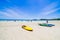 Surfer on Pretty beach and ocean with sailboat