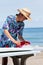 Surfer putting in a surf fin to a surfboard in Japan