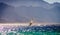 Surfer ride in the sea on the background of the rocky coast in Egypt Dahab