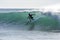 A surfer rides a point break wave at Arugam Bay in Sri Lanka.