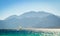 Surfer rides into the sea against the backdrop of the high rocky mountains in Egypt Dahab