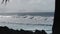 A surfer rides a wave at the wreck