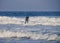 A surfer rides waves in the water