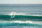 Surfer riding on the huge waves in Pacific ocean at Hanga Roa, Easter island, Chile, South America