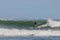 Surfer riding on the surfboards on the foamy waves of the ocean during the daytime in Chilmark