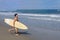 Surfer Running on Beach