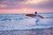 Surfer running on coast in Indonesia