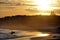 A surfer silhouette against a sunset backdrop