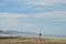 Surfer silhouette carrying surfboard on beach Baja Landscape