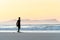 A surfer stretching at Betty`s Bay beach at sunset in the Western Cape, South Africa