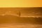 Surfer at sunset on a calm ocean