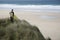 Surfer With Surfboard On Beach Looking At Sea