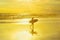 Surfer with surfboard, tropical beach