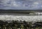 Surfer surfs a perfect wave on a sunny day