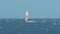 Surfer Wafts on Ocean Merging with Sky on Horizon