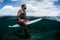 Surfer waits the wave on line up with surf board