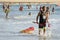 Surfer walking along the beach