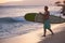 Surfer Walking Surfboard to Water