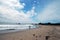 Surfer walks along the beach