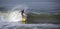 Surfer on wave at sandbar where the Santa Clara River empties into the Pacific Ocean at Ventura California U