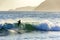 Surfer in the wave at sunset