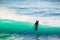 Surfer in wet suit and blue ocean wave. Surfing in blue ocean