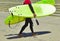 Surfer in wet suit after training and in hands holds surfboards