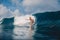 Surfer woman at surfboard on ocean wave. Attractive surf girl on surfboard