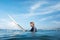 Surfer. Young Man In Wetsuit On White Surfboard Portrait. Handsome Guy In Ocean.