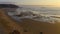 Surfers on Amado beach on sunset