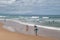 Surfers on the beach in Biarritz, France. Active holidays, active lifestyle.