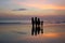 Surfers with boards silhouettes on sunset Kuta beach, Bali, Indinesia