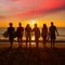 Surfers boys and girls group walking on beach