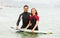 Surfers couple waist deep in water