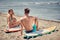 Surfers couple waiting for the high waves on beach - Sporty people with surf boards on the beach - Extreme sport .