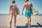 Surfers going to surf at the beach -Attractive man and woman at