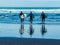 Surfers hitting the waves at Piha Beach Auckland New Zealand