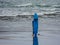 Surfers hitting the waves at Piha Beach Auckland New Zealand