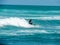 Surfers hitting the waves at Piha Beach Auckland New Zealand