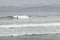 Surfers at Morro Rock Beach, California