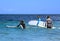 Surfers in ocean with surf boards