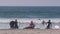 Surfers in ocean waves with surfboards, people surfing on beach, California USA.