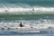 Surfers on Piha beach, New Zealand