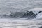 Surfers riding huge waves on the west coast, close to Pillar Point and Mavericks Beach, Half Moon Bay, California