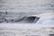 Surfers riding huge waves on the west coast, close to Pillar Point and Mavericks Beach, Half Moon Bay, California