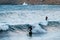 Surfers riding a wave at Losari in Corsica