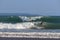 Surfers riding wave and a woman at the forground at Echo Beach C